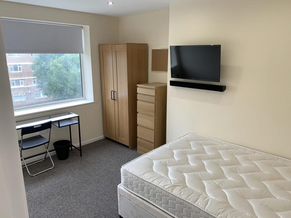 A spacious and well-lit double bedroom featurin...