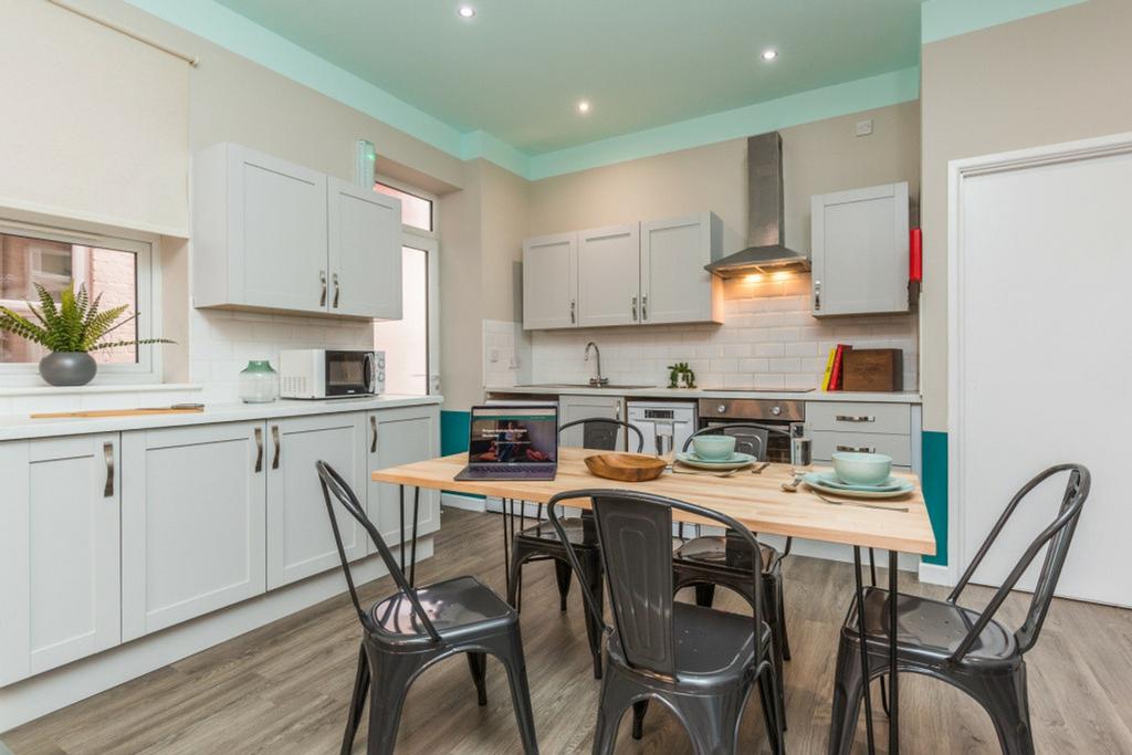 A bright and modern kitchen equipped with ample...