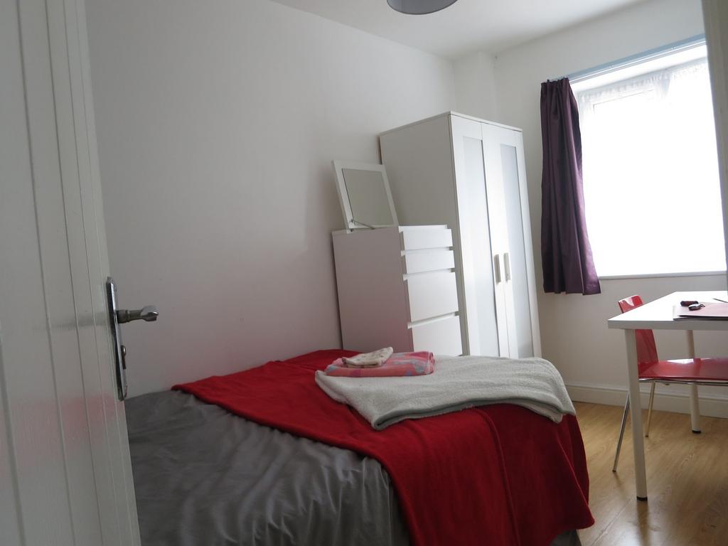 Bright, simply furnished single bedroom with a ...