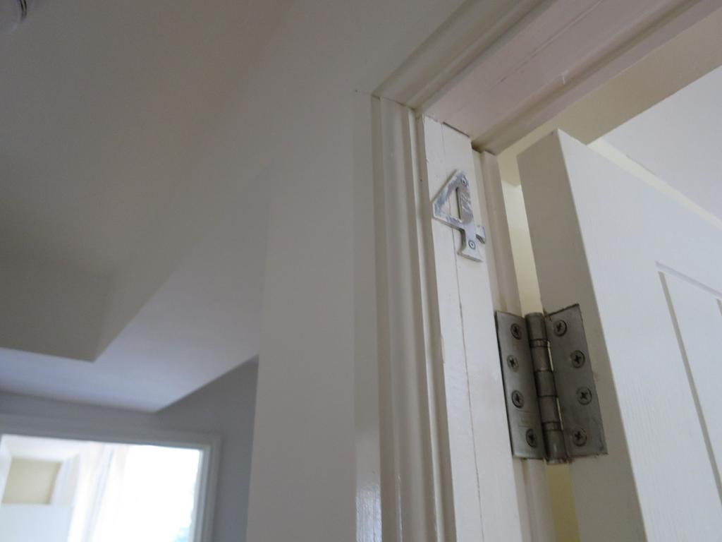 Close-up view of a white interior doorway and h...