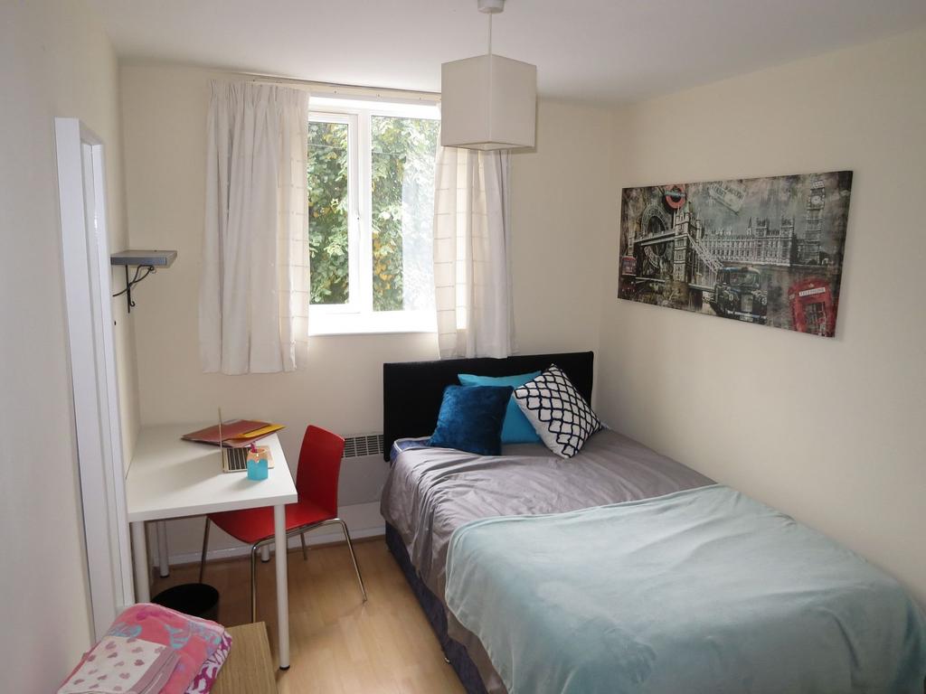 Bright, neatly presented bedroom with a comfort...