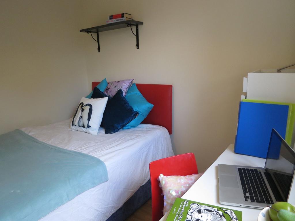 Bright, neatly presented bedroom with a comfort...