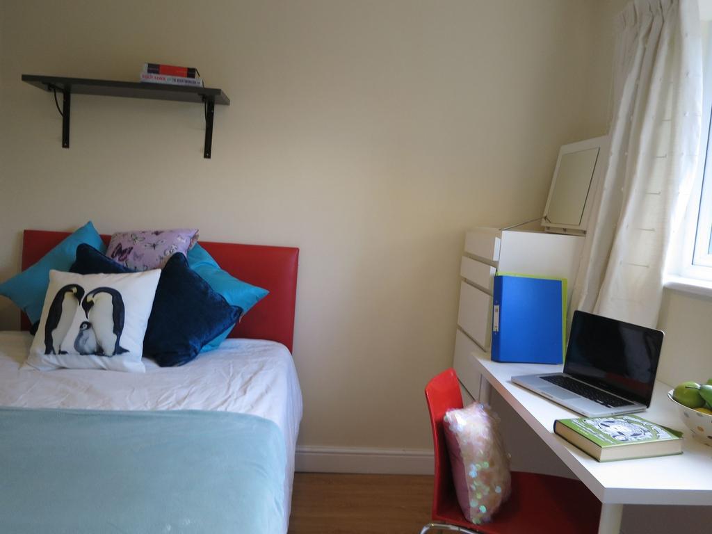 Bright, neatly presented bedroom with a comfort...