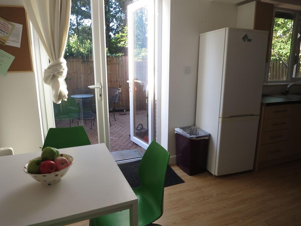 Bright kitchen/dining area with a white table, ...