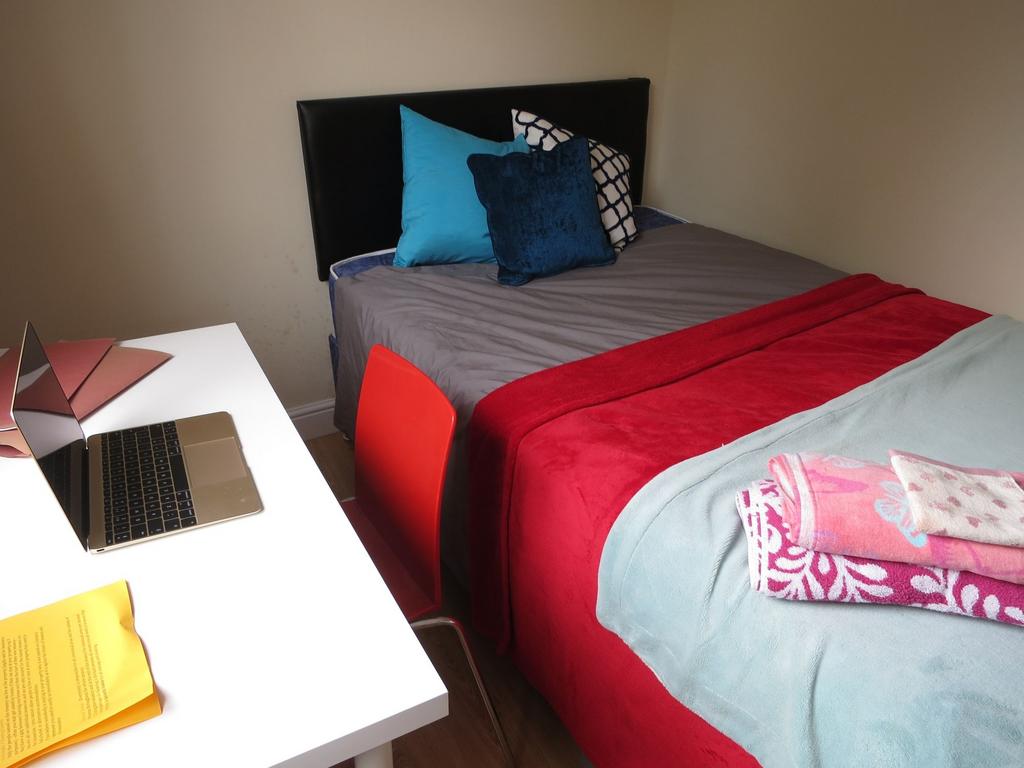 Neat single bedroom with a comfortable bed dres...