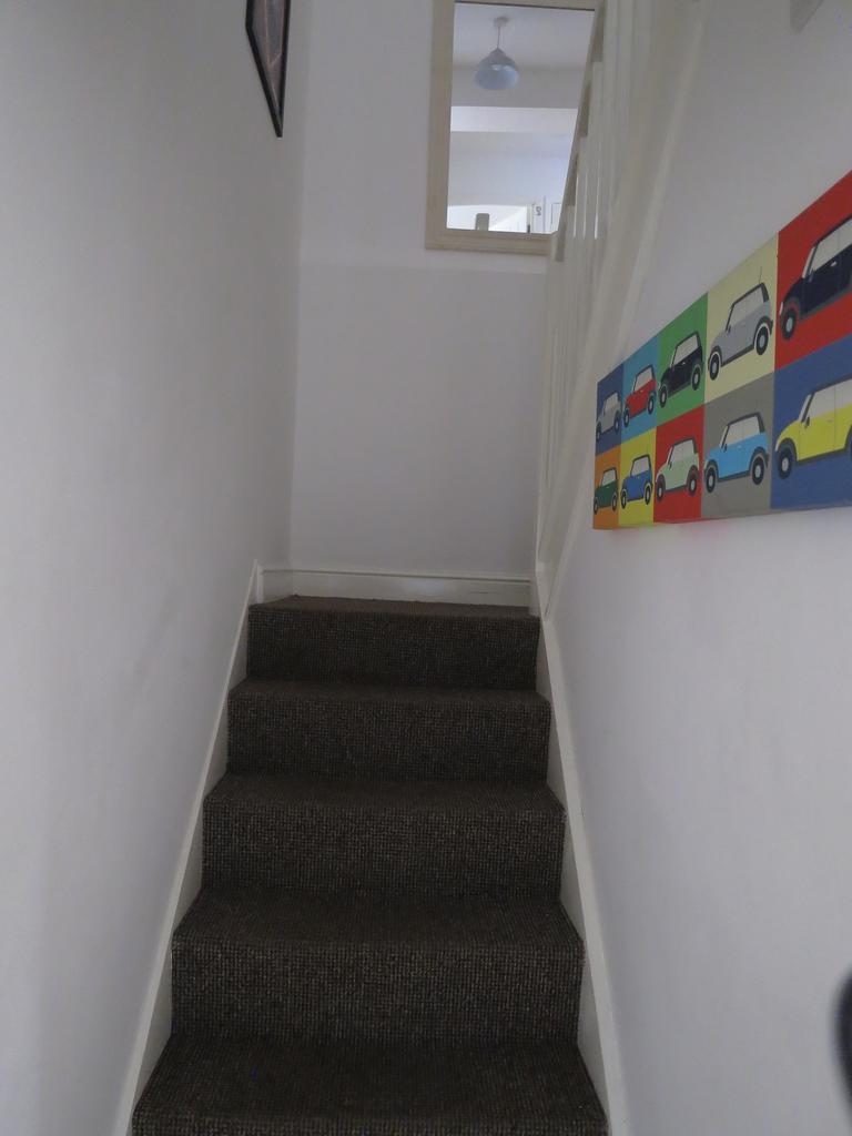 A tidy staircase leading to the upper levels, w...