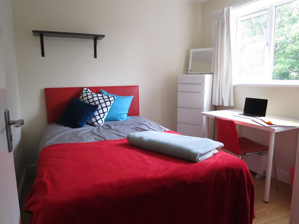 A bright and cozy double bedroom featuring a co...