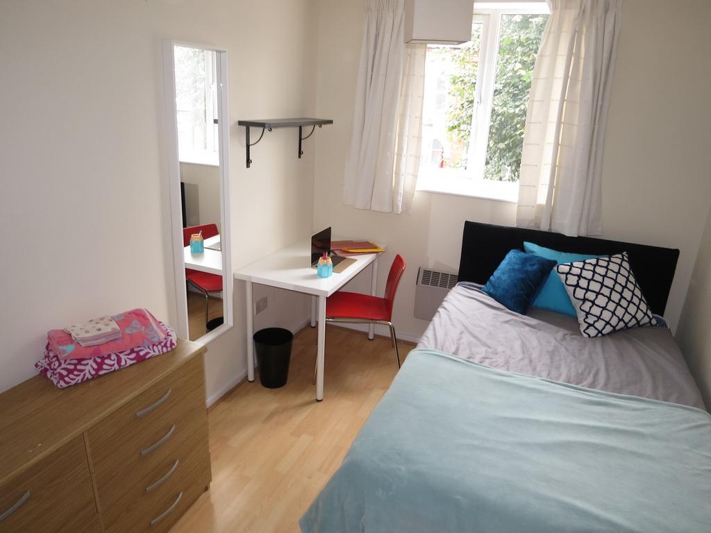 A bright and tidy double bedroom featuring a co...