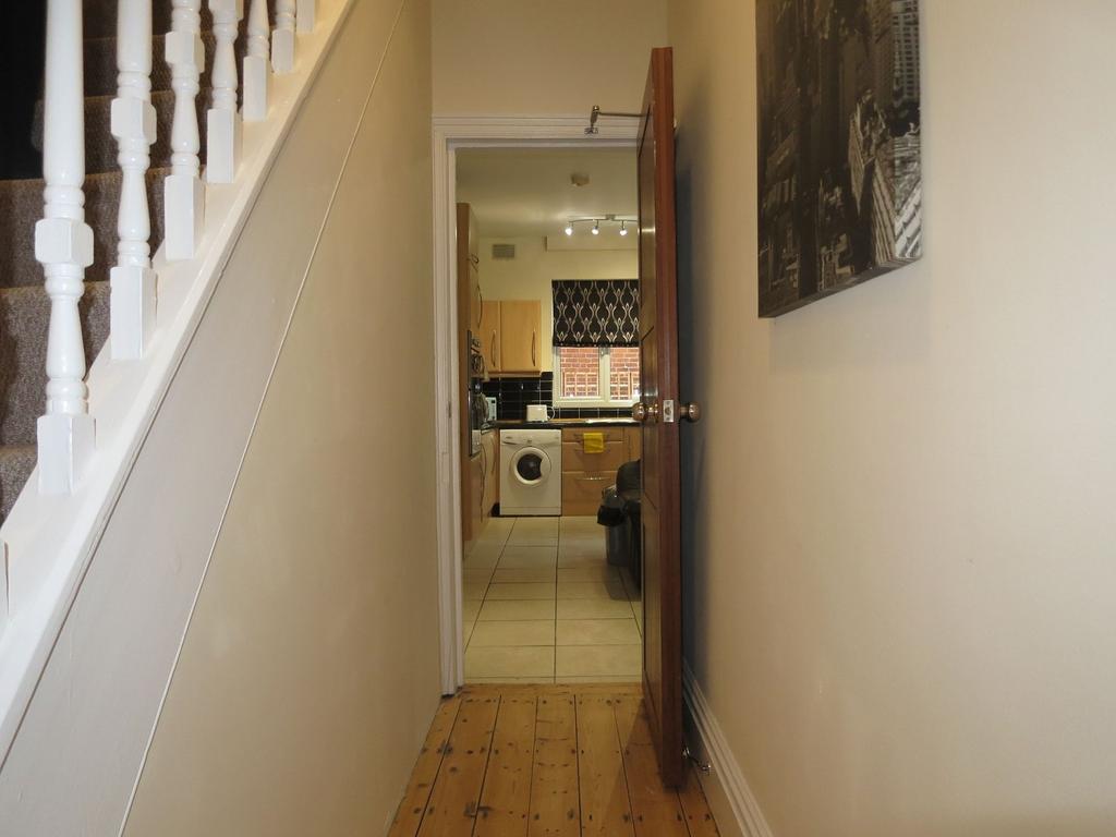 Bright, well-maintained hallway with wooden flo...