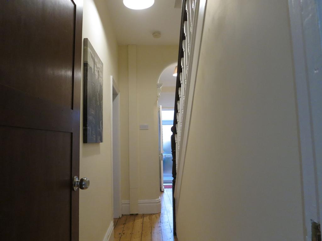Bright, well-kept hallway with polished wooden ...