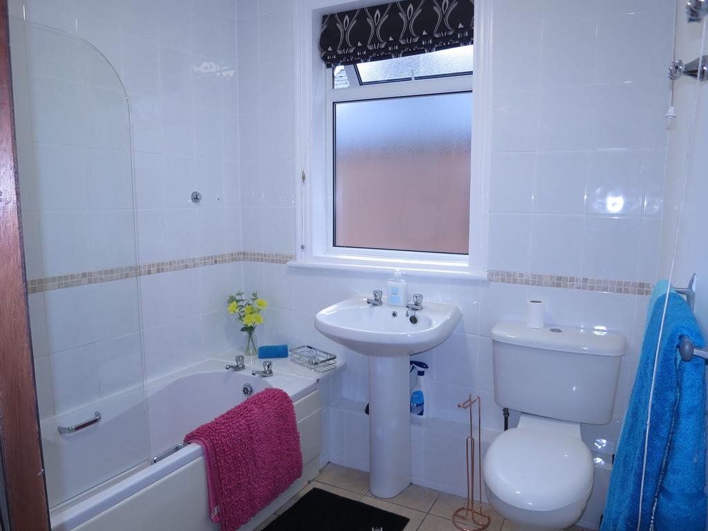 Bright, well-presented bathroom with a white ba...