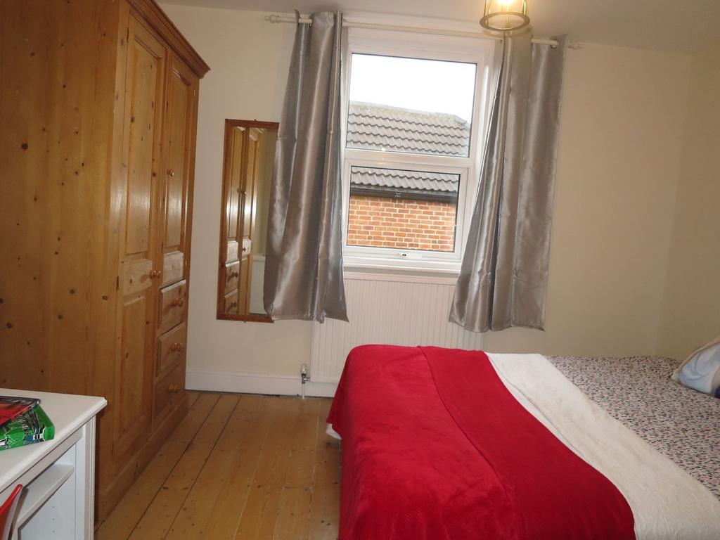 Bright, neatly presented bedroom with wooden fl...