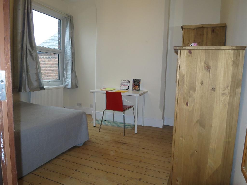 Bright, neatly presented bedroom with wooden fl...