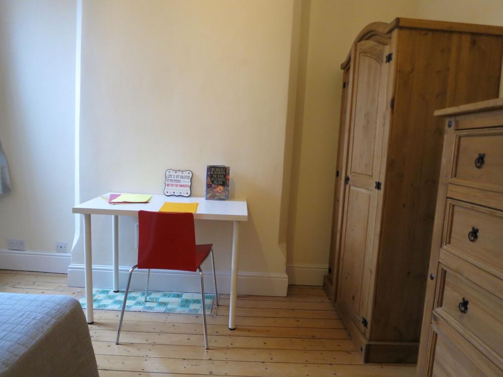 Bright, simply furnished bedroom nook with a wh...