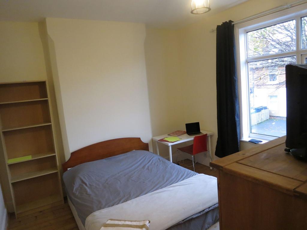 Bright double bedroom with a large window, simp...