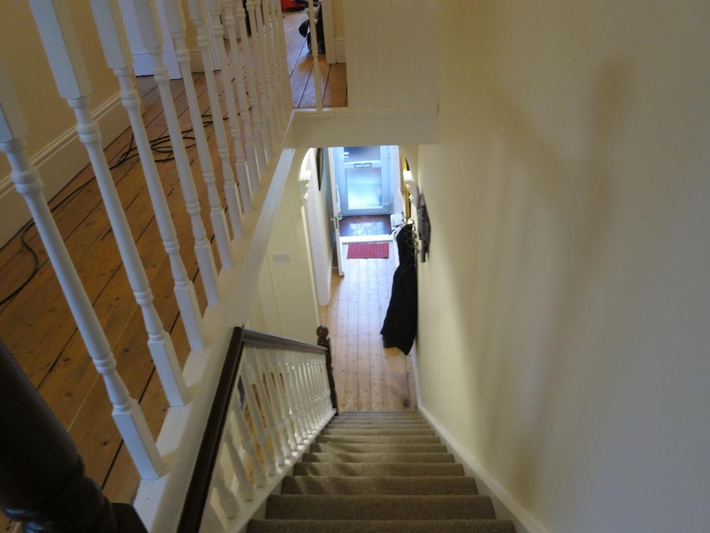 Bright, well-maintained hallway and staircase w...