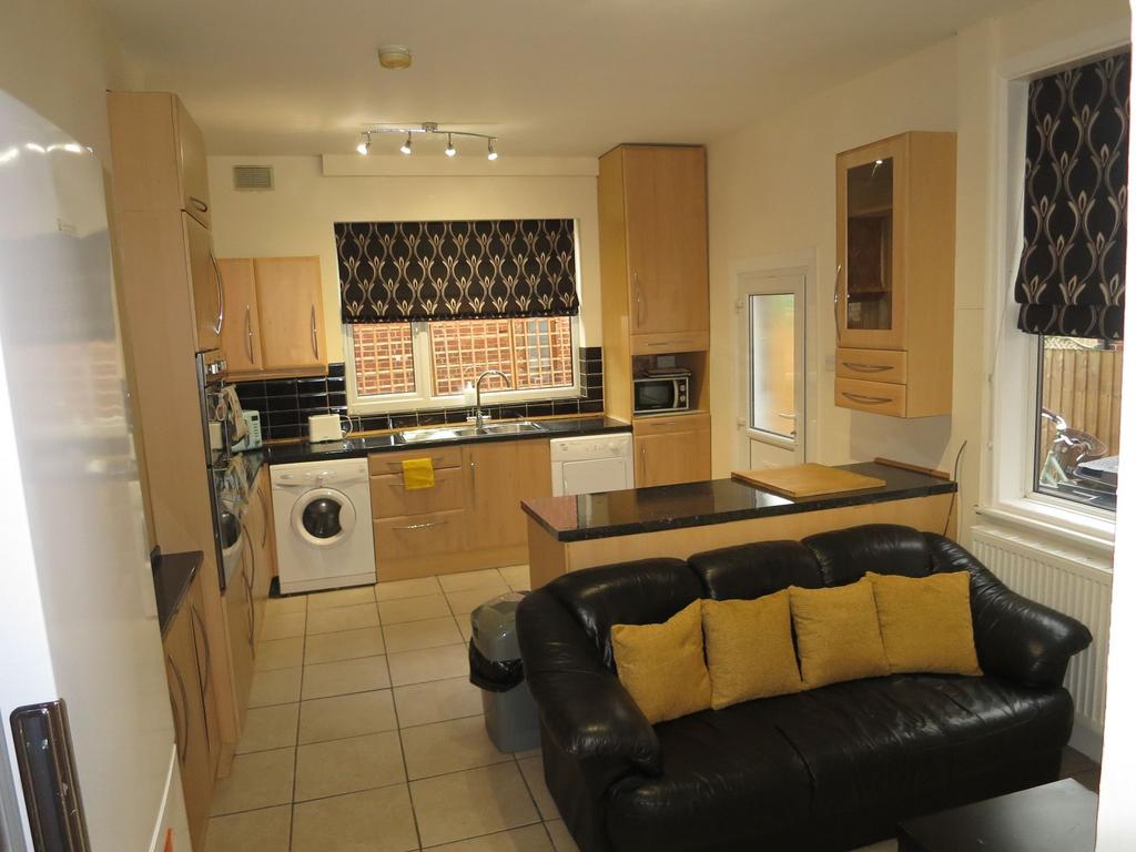 Bright open-plan kitchen with light wood cabine...
