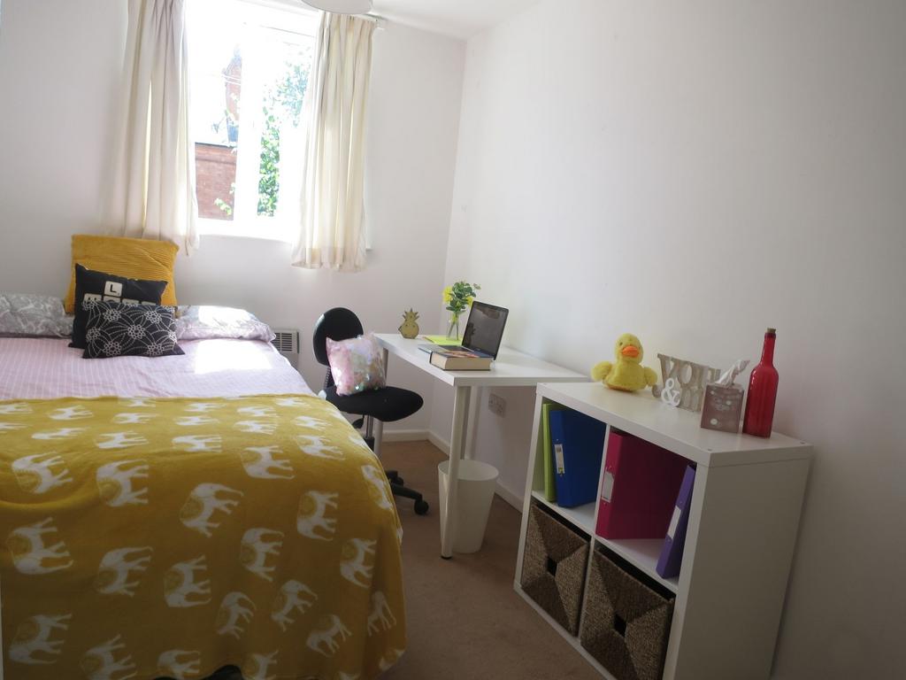 Bright, neatly presented bedroom with a comfort...