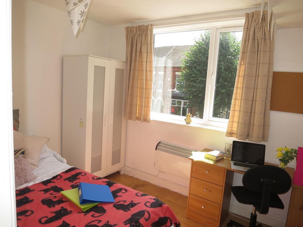 Bright, neatly presented bedroom with a large w...