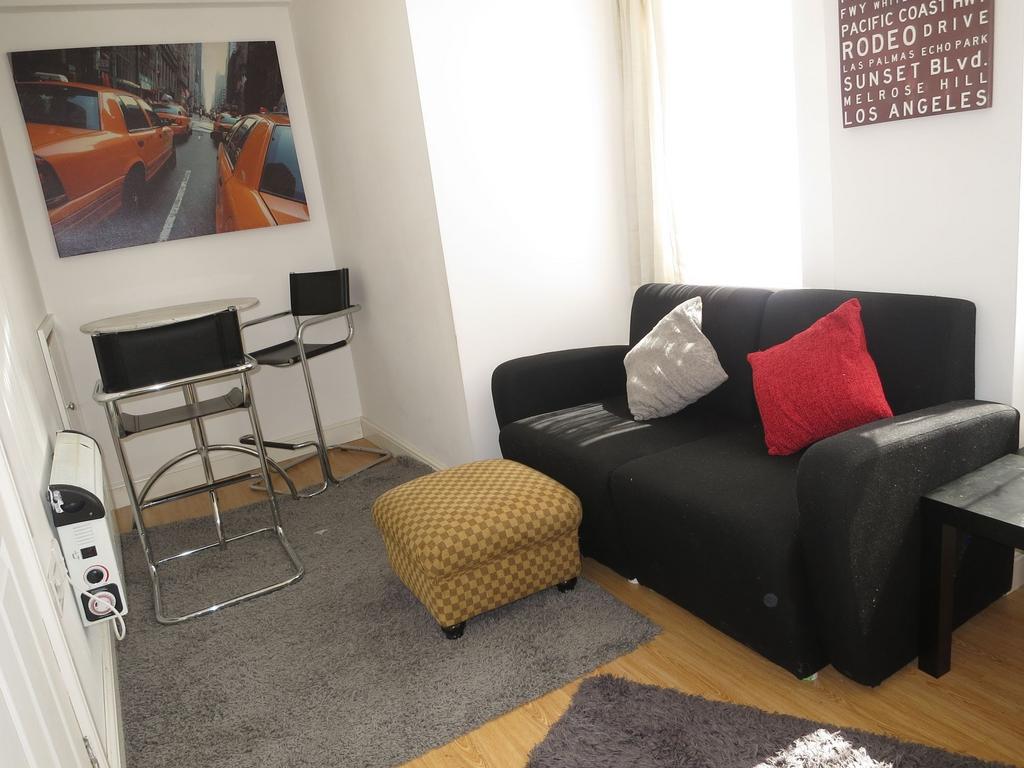 Bright compact living area with a black two-sea...