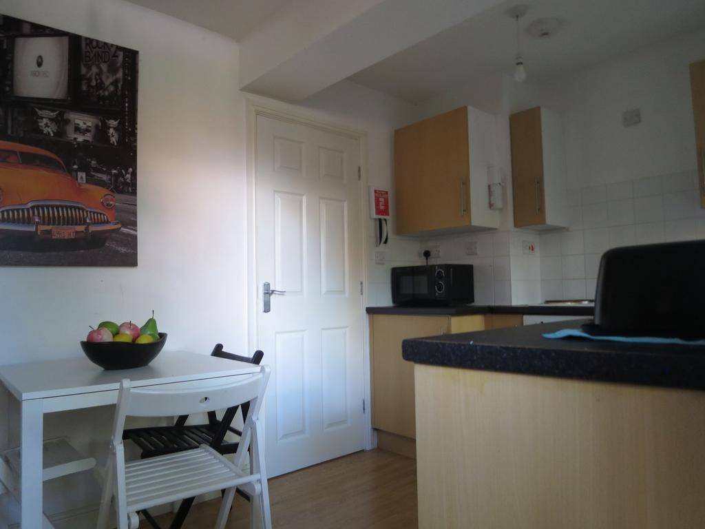 Bright compact kitchen with light wood cabinets...