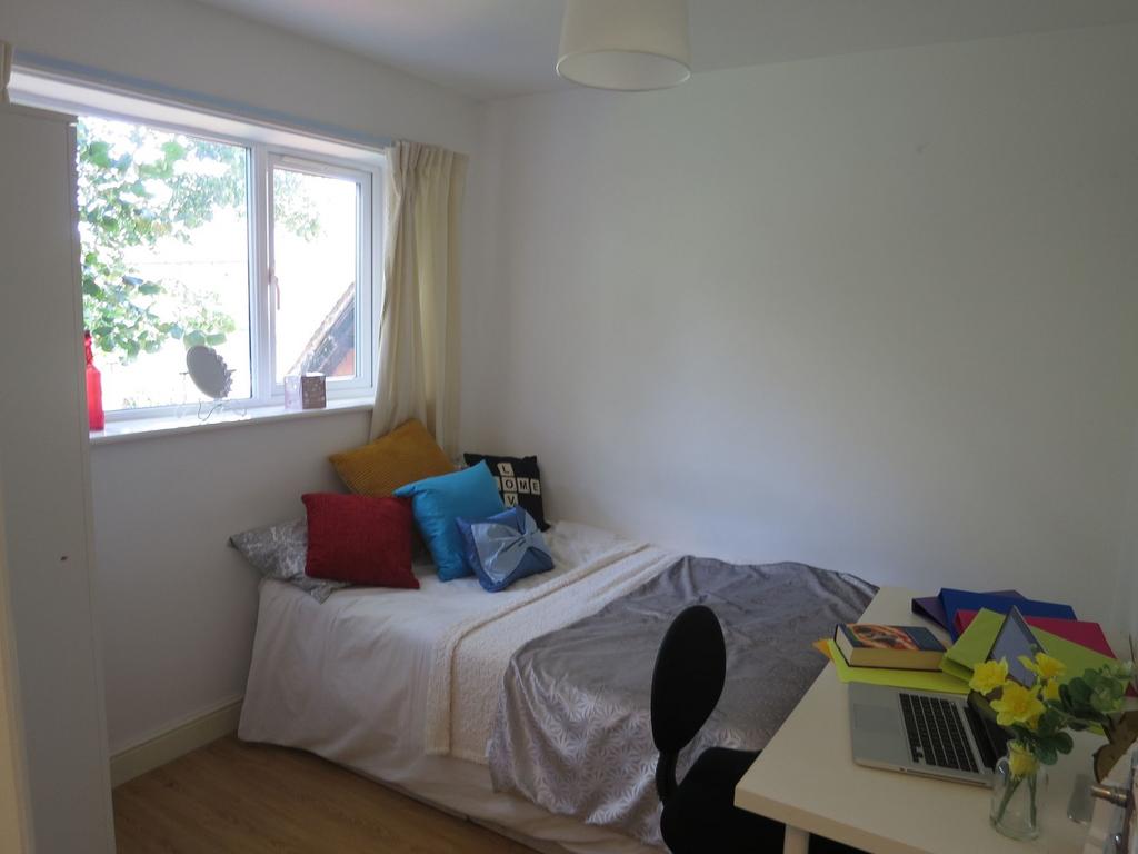 Bright, neatly presented bedroom with a comfort...