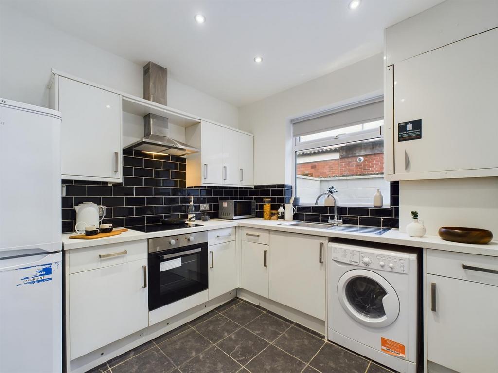 A modern and tidy kitchen with ample storage an...