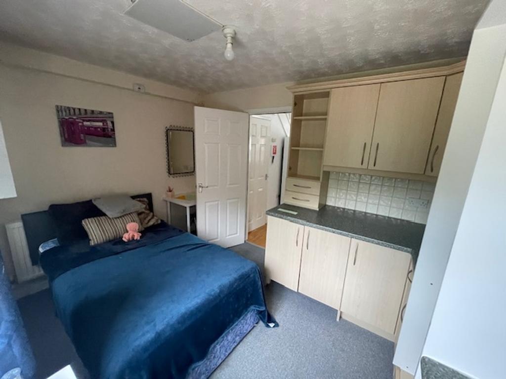 A cozy double bedroom featuring ample storage a...