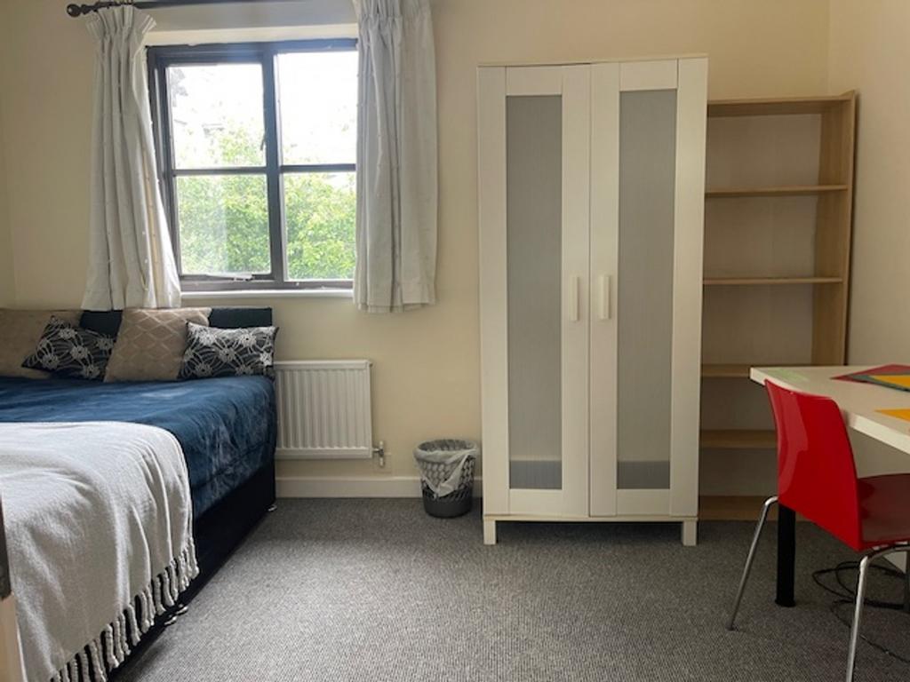 A bright and inviting double bedroom with ample...