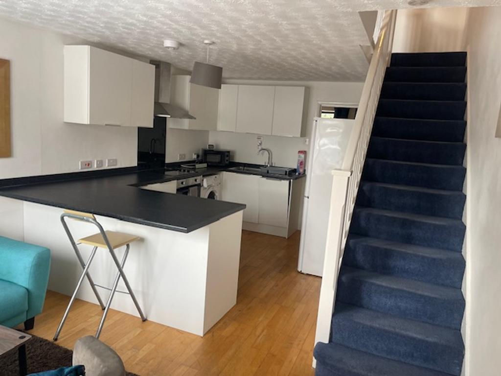 A bright and modern kitchenette with ample spac...
