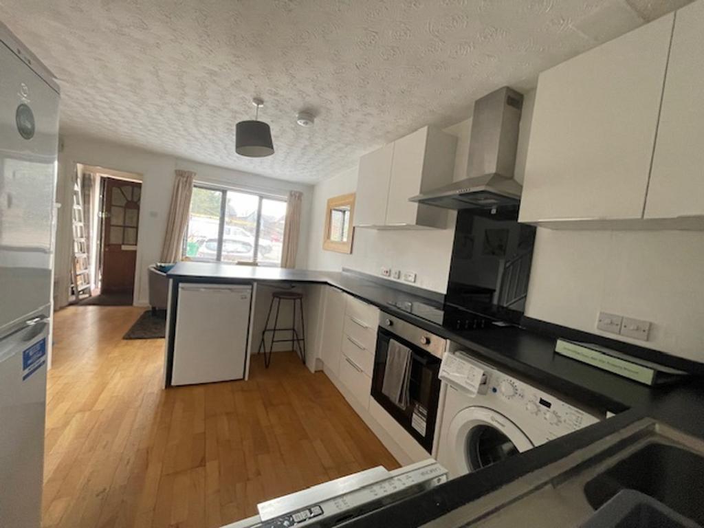 A bright and modern kitchen equipped with essen...