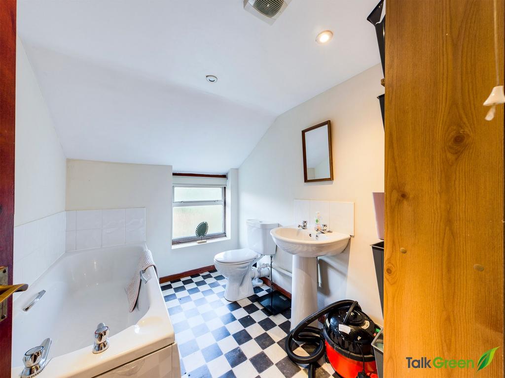 Bright bathroom with a checked tile floor, whit...