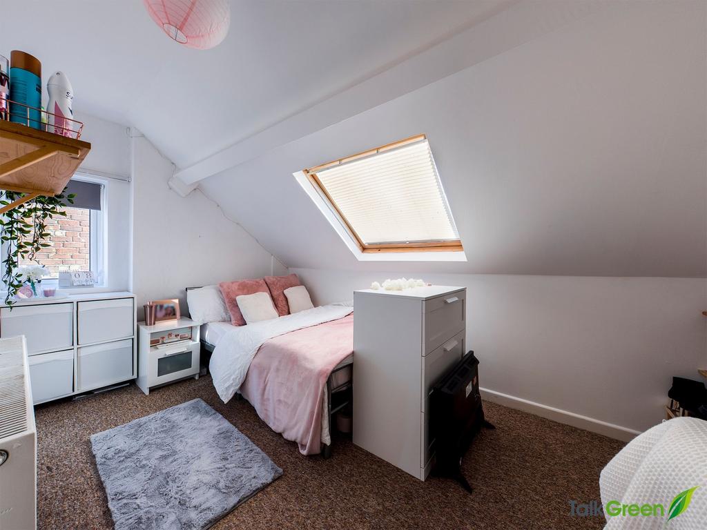 Bright, cosy attic bedroom with a skylight, sof...