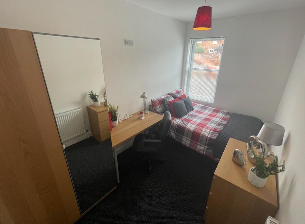 A bright and inviting double bedroom featuring ...