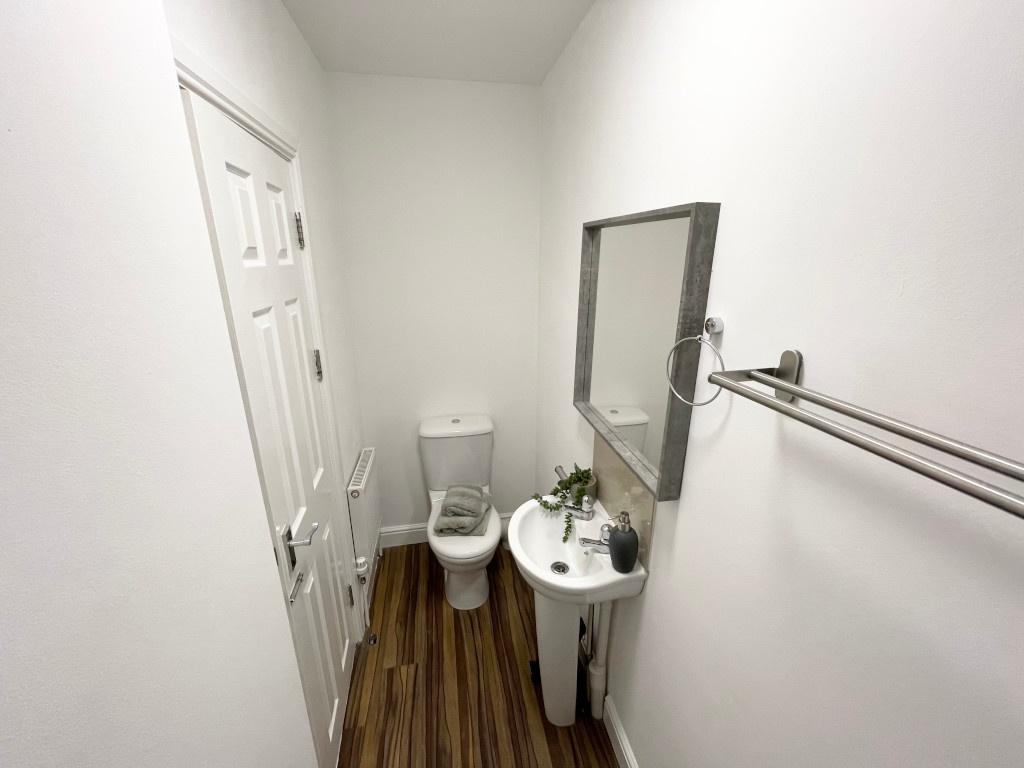 Bright, freshly decorated WC with a compact sin...
