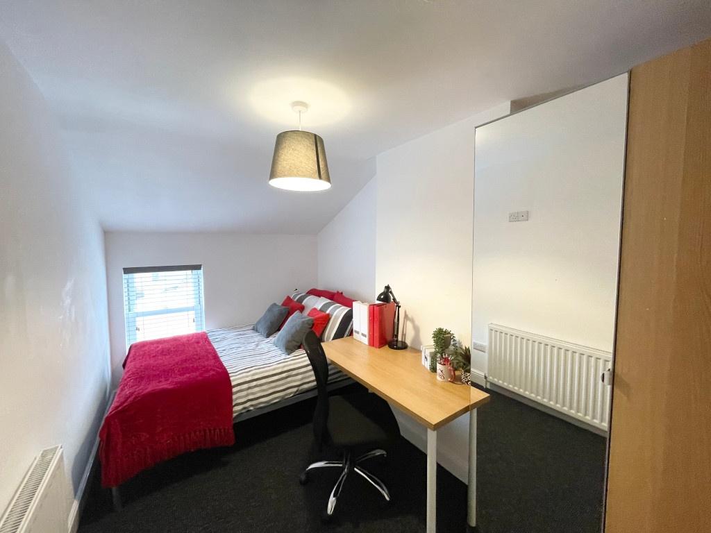 Bright, neatly presented bedroom with a comfort...