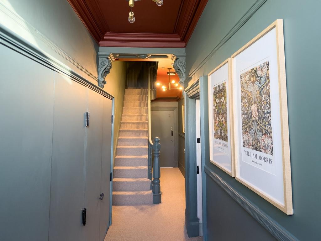 Bright, stylish hallway with decorative mouldin...