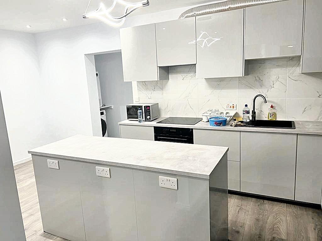 Bright modern kitchen with a central island, in...