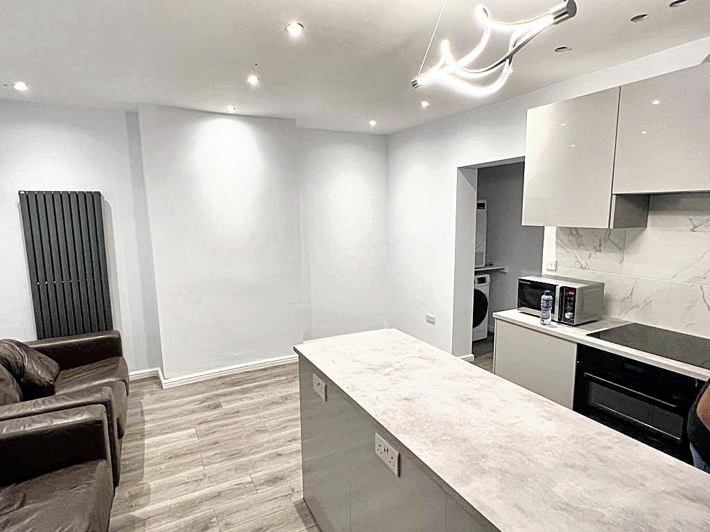 Bright modern open-plan kitchen with a central ...