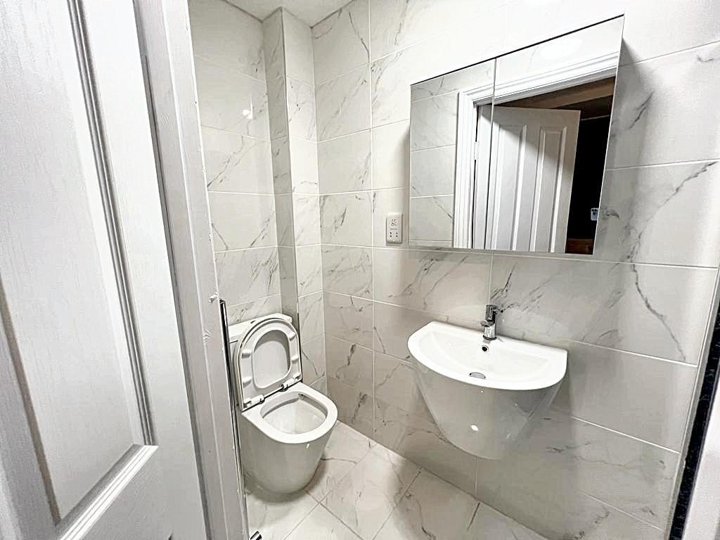 Bright, modern bathroom with wall-mounted basin...