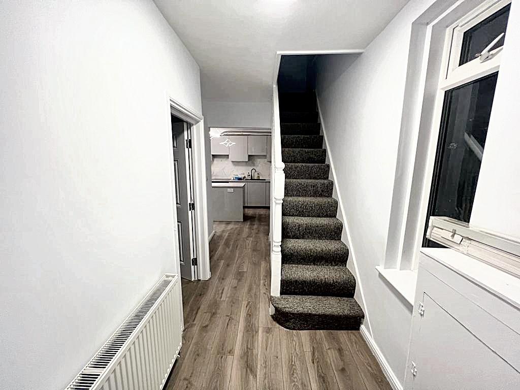 Bright modern hallway with wood-effect flooring...