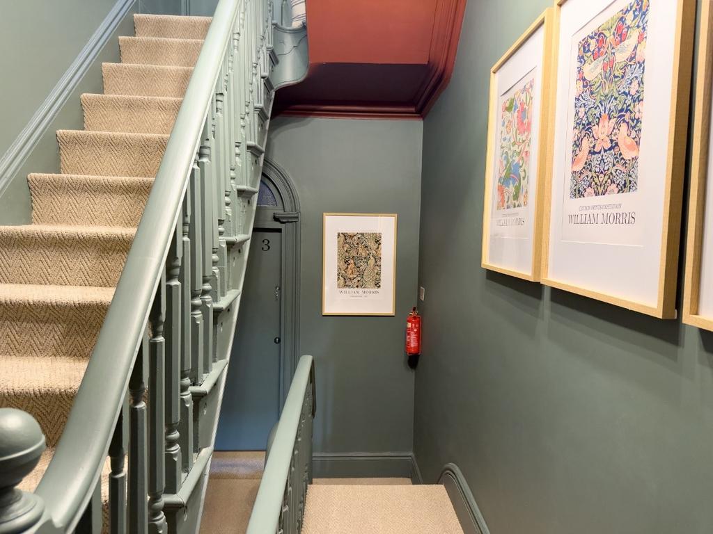Well-kept interior staircase with carpeted step...
