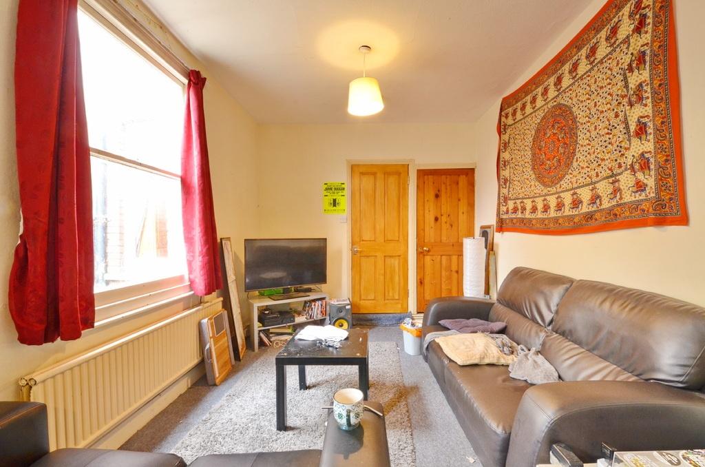 Bright and comfortable living room with large w...