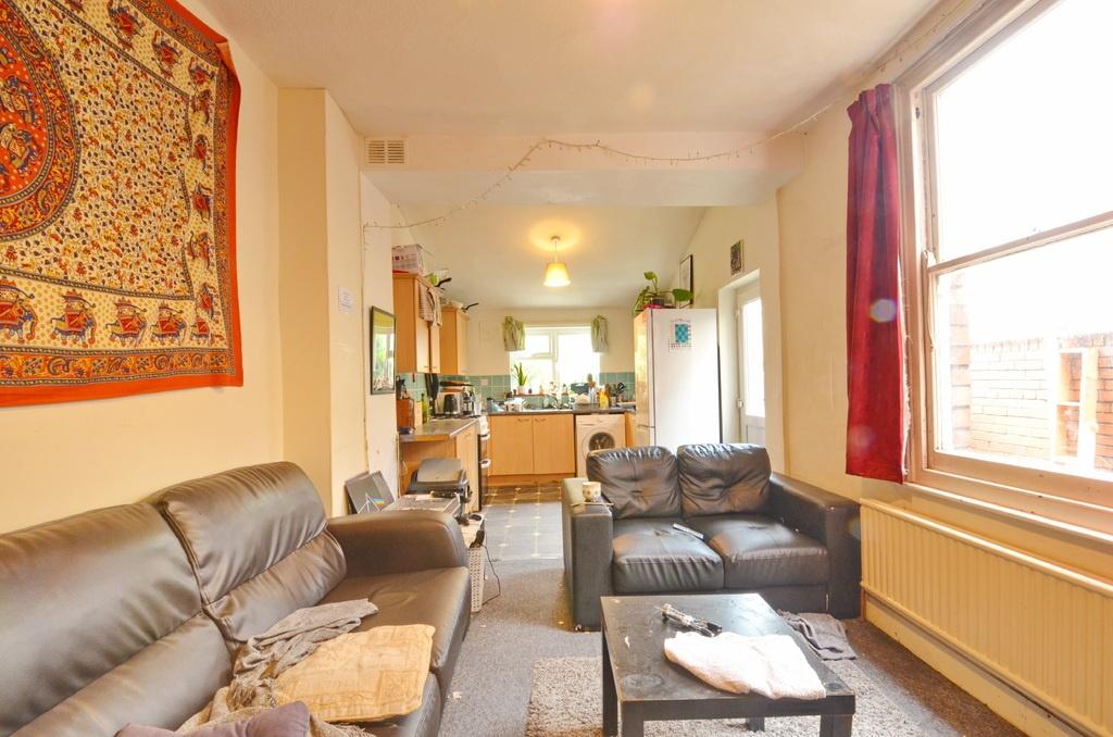 Bright, comfortable living room with large wind...