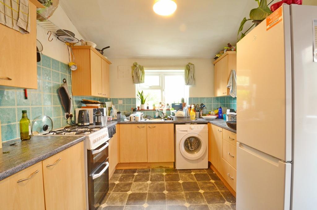Bright, practical kitchen with ample storage, m...