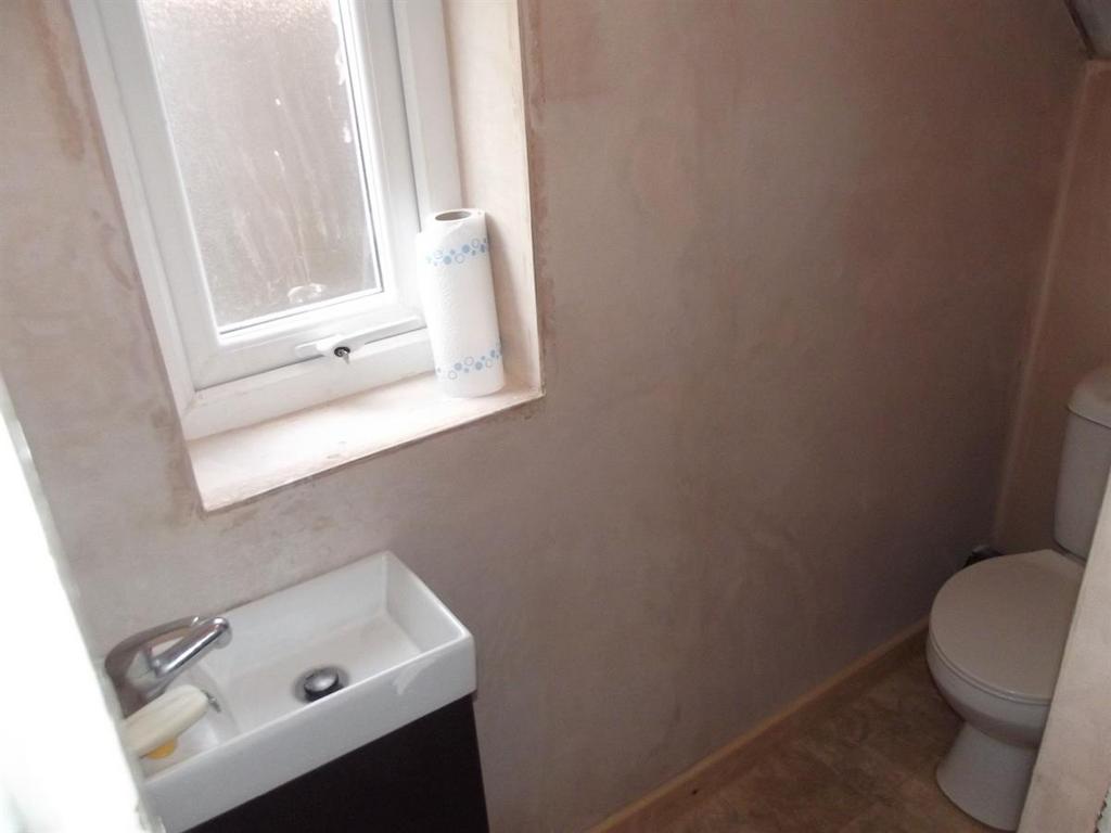 Compact, clean bathroom with a modern basin, co...
