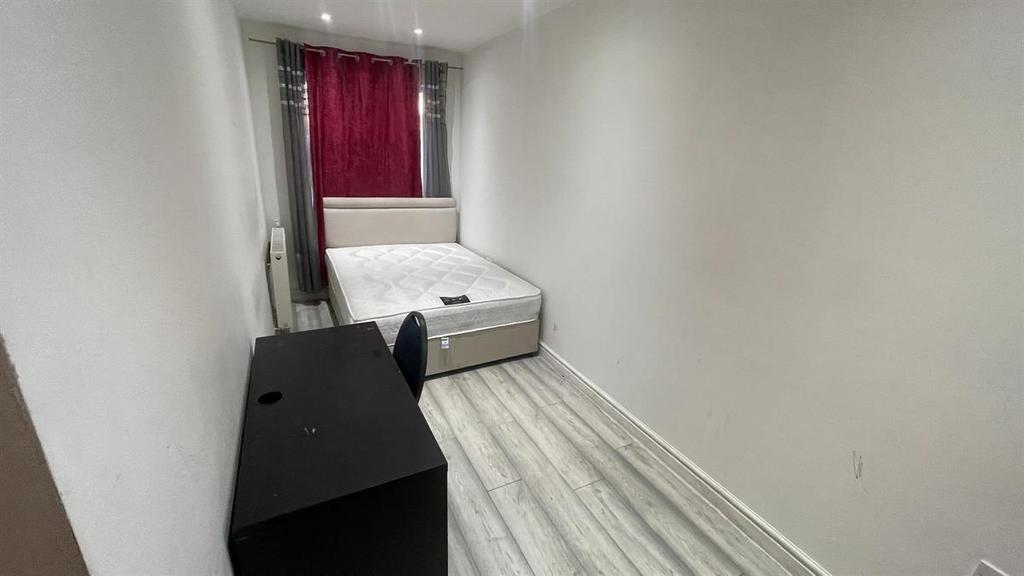Bright, simply furnished single bedroom with a ...