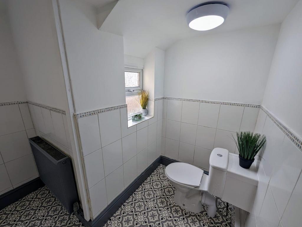 Bright, freshly tiled bathroom with patterned f...
