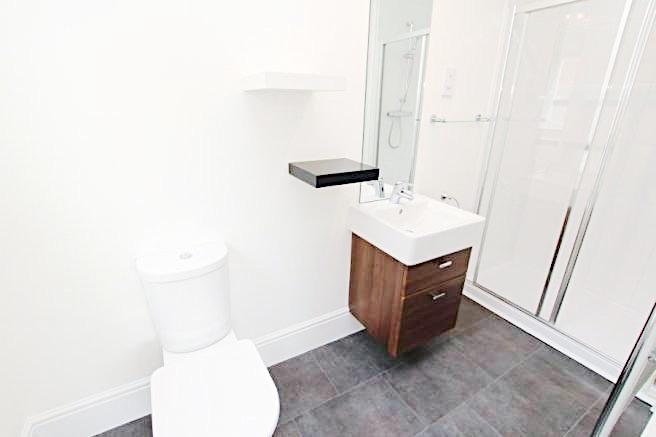 Bright, modern bathroom with a walk-in shower, ...