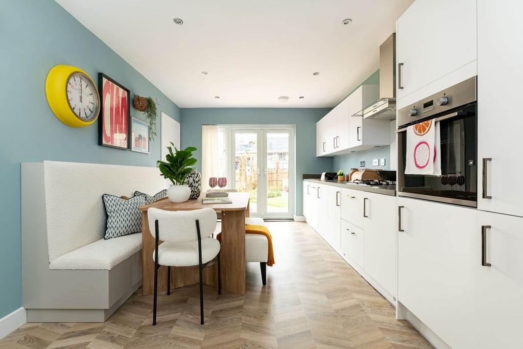 The kitchen/dining area boasts double doors out...
